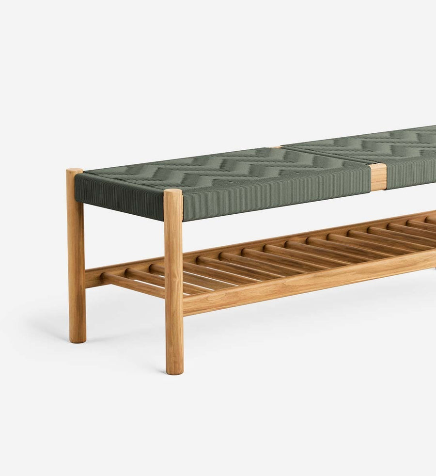 A modern wooden bench with a natural oak frame, a lower slatted shelf, and a dark green quilted cushion on top, shown against a plain white background.