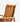 Close-up of a wooden chair with woven tan straps on a light gray background.